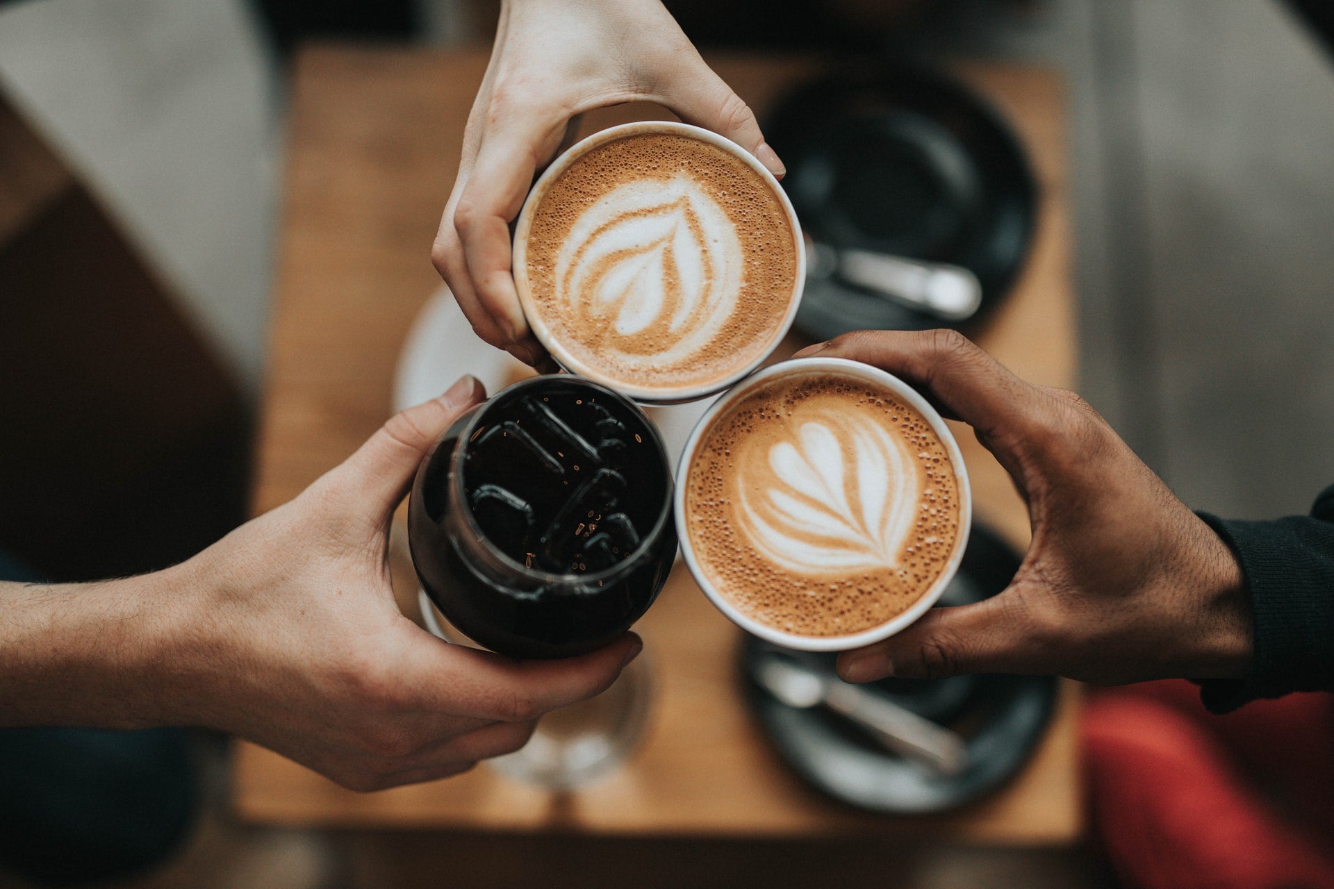people holding cups of coffee